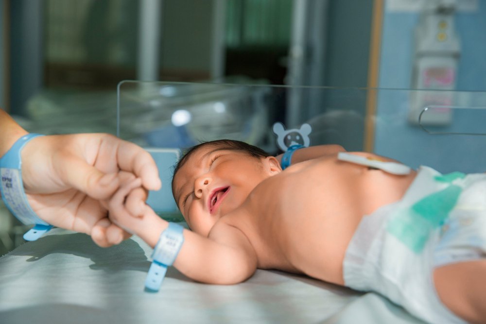 Newborn baby being gently examined in the hospital after delivery